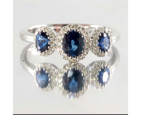 An 18ct gold sapphire and diamond triple cluster ring, total sapphire weight 0.84ct, total diamond weight 0.14ct, each engrav