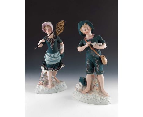 A pair of Gebruder Heubach bisque figures of seaside children, both in dark teal costumes, encrusted, the girl holding a net,