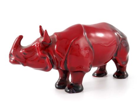 Charles Noke for Royal Doulton, a Flambe Rhino figure, modelled standing, head raised, printed marks and K, 17cm long