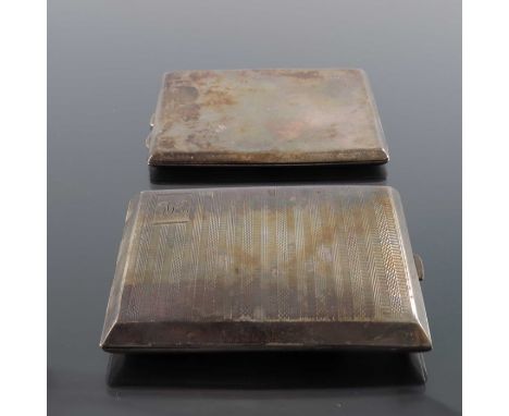 Two George V silver cigarette cases, Birmingham 1928 and 1929, one plain cushioned rectangular form, the other hip fitting wi