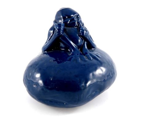 A Royal Doulton Titanian ware grotesque imp, circa 1913,  seated on a rock, smoking a pipe and holding a cup, printed marks, 