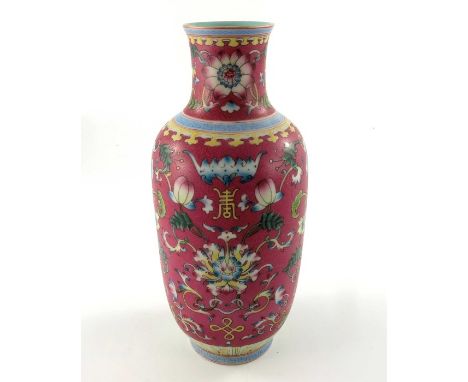 A Chinese famille rose vase, Qianlong mark, rounded shoulder rouleau form, enamelled with foliate scrolls and lotus flowers o