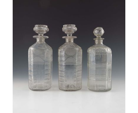 A pair of George III cut glass spirit decanters, circa 1820, chamfered square section, with hobnail segmented panels and hori