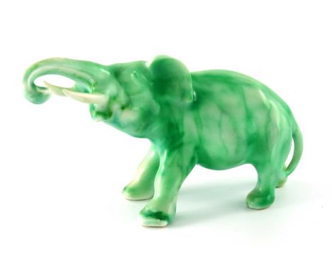 Charles Noke for Royal Doulton, a Jade Elephant figure, modelled charging, printed marks and signed, 18cm long