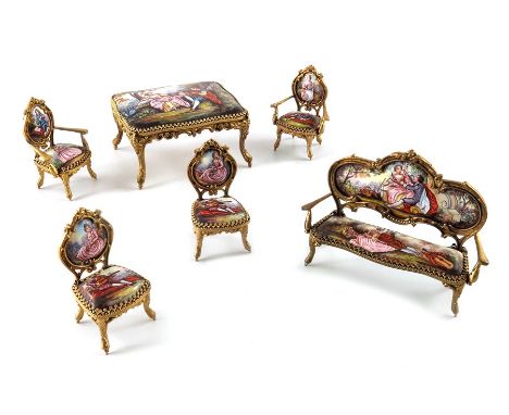 An Austrian gilt metal and enamelled miniature salon suite with a Swiss clock work musical table by Reuge Ste Croix, in the L