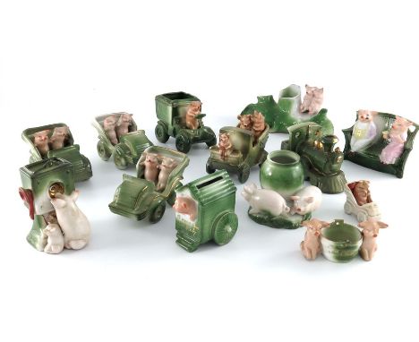 A large collection of German porcelain novelty fairings, in the form of pigs, including cars, handbags, bench etc. together w
