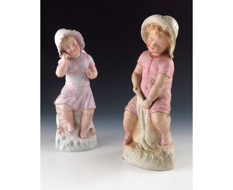 A pair of Gebruder Heubach bisque figures of seaside children, both in pink costumes, modelled sitting, the girl listening to