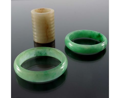 Two Chinese jade type carved stone bangles and a ring, internal diameter 6cm (3)