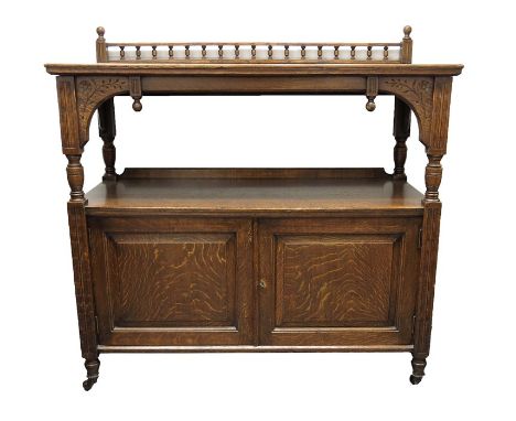 An Aesthetic Movement oak buffet sideboard, the bobbin galleried back, on pierced round arched side aprons and segment corner