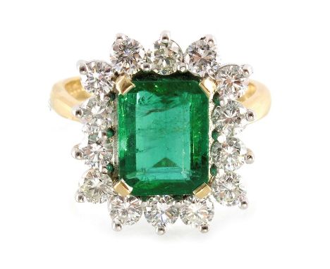 An 18ct gold rectangular-shape emerald and brilliant-cut diamond cluster ring, emerald estimated weight 3.90cts, estimated to