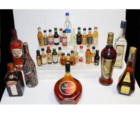 A group of various bottles of alcohol to include Boukha Gold, a special edition of rosé by designer visionary Christian Audig