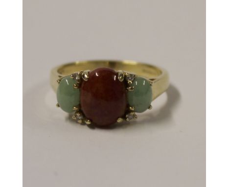 A 14ct yellow gold ladies' dress ring, trilogy-set with green and amber jade, interspersed with small diamonds, size R, appro