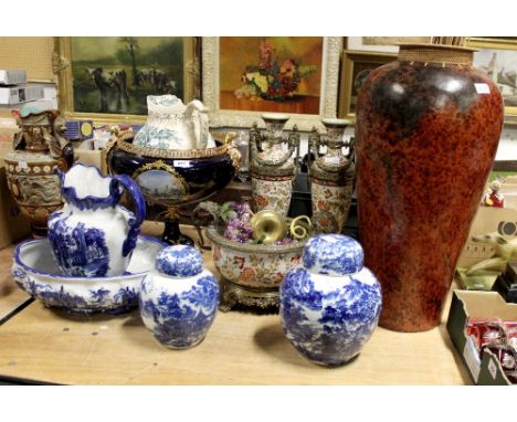 A pair of ceramic baluster vases with terracotta and multicolour floral decoration, with ornate metal decoration of banding a