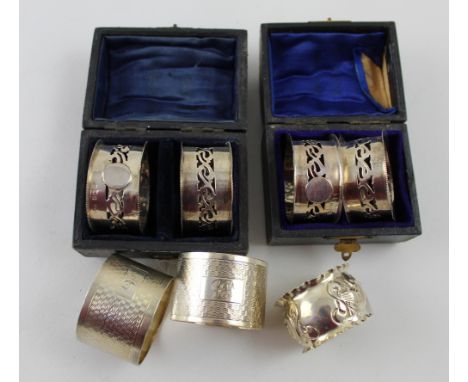 Two Edward VII hallmarked silver cased sets of two matching napkin rings, Ridley Brothers &amp; Merton, Birmingham 1905, a pa