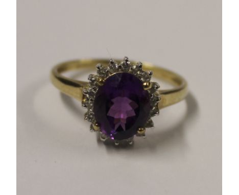 A 9ct yellow gold ladies' dress ring with central facet-cut amethyst stone and small white stone surround, size N, approx 3.3