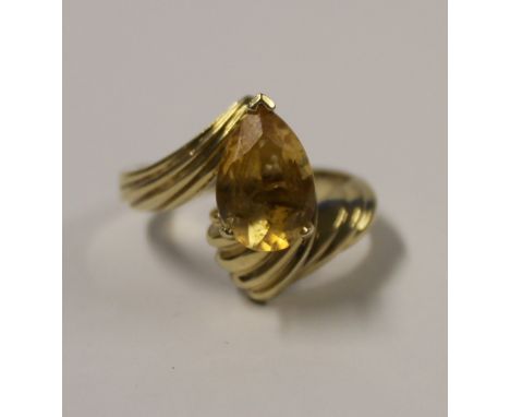 A 9ct yellow gold ladies' dress ring with pear-shaped amber-coloured stone (tests as tanzanite), size S, approx 7.5g.