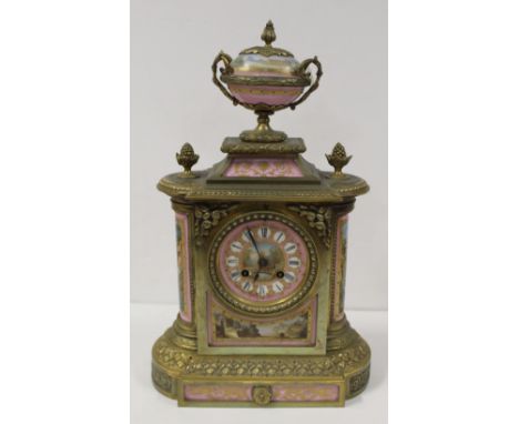 A 19th century French gilt and brass mantel clock with hand painted and gilt decorated ceramic panels depicting various lands