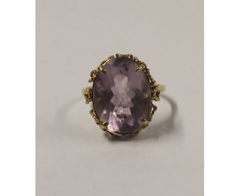 A 9ct yellow gold ladies' dress ring with large oval facet-cut amethyst, approx 10ct, size Q, approx 5.4g.