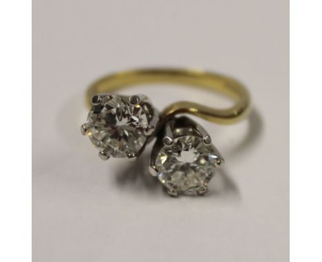 An 18ct yellow and white gold two-stone diamond ring, claw settings on plain twisted shoulders, diamond weight approx 3.2ct, 