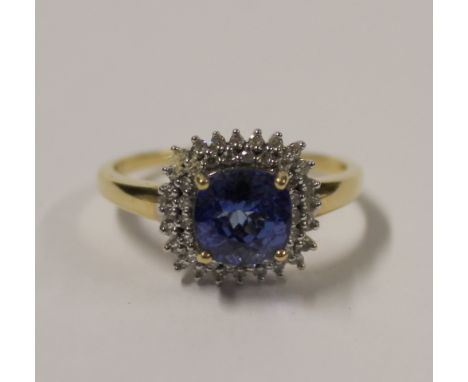 An 18ct yellow gold ladies' dress ring, square facet-cut blue stone (tests as tanzanite) within a double border of small whit