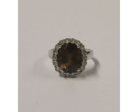 A 9ct white gold ladies' dress ring, central oval smoky quartz stone and small white stone surround, size L, approx 4.5g.