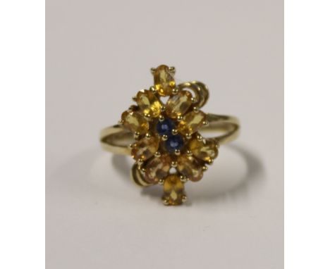 A 9ct yellow gold ladies' floral-set dress ring with blue and orange topaz, size T, approx 4.9g.