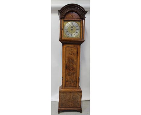 An 18th century oak and walnut inlaid longcase clock by James Barton, Ormskirk, arched top above a silver and gilded dial set