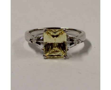 An 18ct white gold ladies' dress ring set with pale yellow and white cubic zirconia, size T, approx 5g.