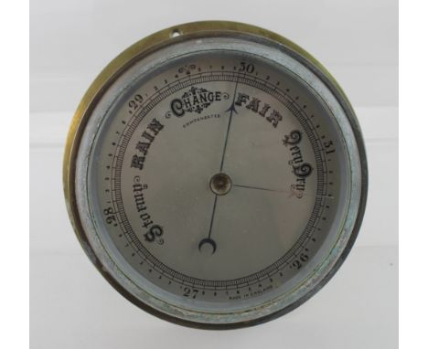 A brass-cased ship's barometer, diameter 19cm.