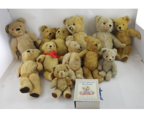 A collection of blond and golden mohair vintage teddy bears with glass eyes, stitched noses and mouths.