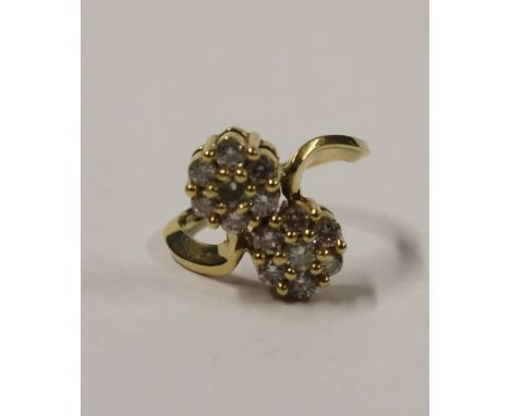 A 14ct yellow gold ladies' dress ring, floral-set with two florets on a twist, each set with seven white diamonds, size M, ap