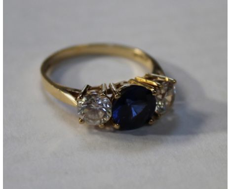 A 14ct yellow gold ladies' dress ring with facet-cut sapphire and large cubic zirconia to either size, size Q, approx 7.6g.