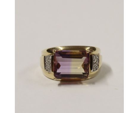 A 14ct yellow gold ladies' dress ring with emerald-cut multicolour amethyst stone, small diamond chips to the shoulders, size