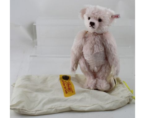 A modern Steiff pink teddy bear with carry bag, length 30cm.