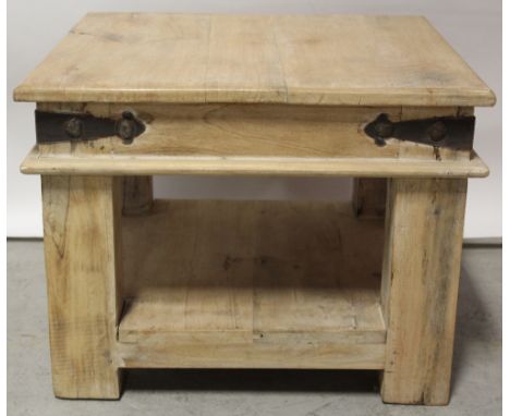 A modern hardwood coffee table of square form, with under tier shelf, raised on block supports, width 60cm.