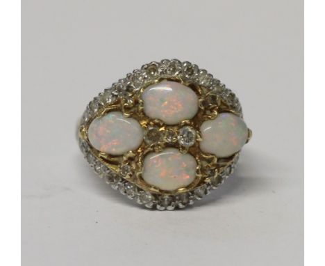 An 18ct white gold ladies' opal and diamond cluster ring, four oval cabochon-cut opals with three single cut diamonds to the 