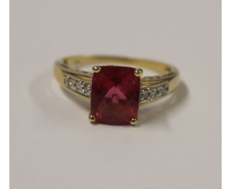 A 14ct yellow gold ladies' dress ring, central multi-cut pink tourmaline with small diamonds to the shoulders, size S, approx