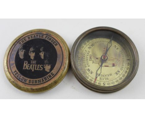 A Beatles brass Yellow Submarine compass, diameter 8cm.