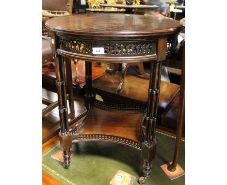 An early 20th century mahogany circular occasional table with single lower shelf, on faux bamboo supports to castors, diamete