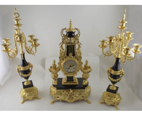 A 20th century David Phipp clock garniture in the French style, urn and griffin head decoration above a gilded and enamel whi