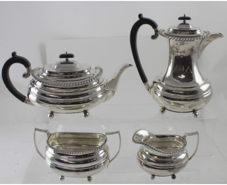 A George V hallmarked silver four-piece tea service, hot water jug, teapot, sucrier and milk jug, William Hutton &amp; Sons L