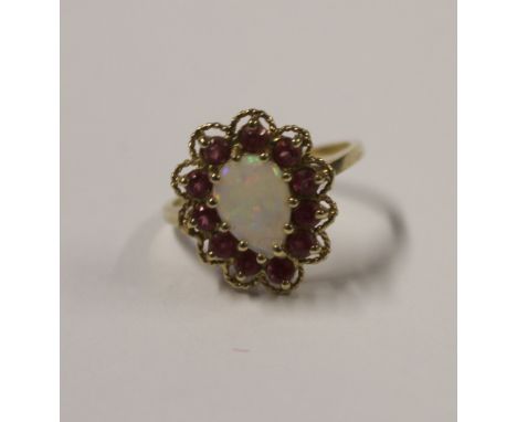 A 9ct yellow gold ladies' dress ring with pear-shaped cabochon opal  with floral pink stone surround, size Q, approx 4g.