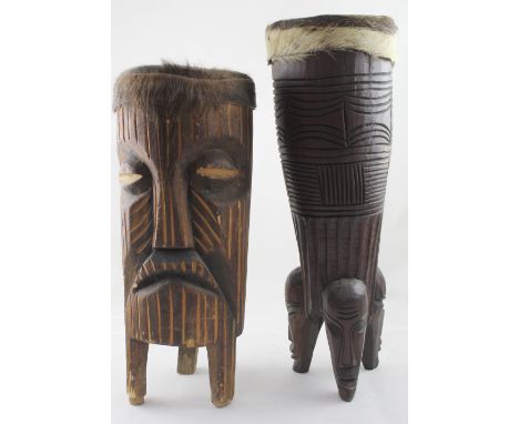 Two African 20th century hide-covered bongo drums with carved stylised detail, height of largest 62cm (2).