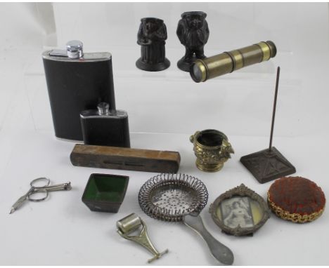 A pair of cast iron inkwells in the form of a lady and gentleman retiring to bed, vintage pin cushion, hip flask, a small spr