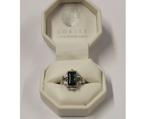 A 14ct white gold ladies' dress ring with rectangular ammonite stone and small diamonds to the shoulders, size S, approx 6.1g