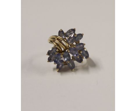 A 9ct yellow gold ladies' dress ring, abstract floral-set with lilac stones, size L, approx 5.2g.