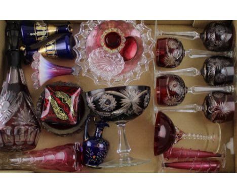 A cut glass ruby overlay decanter and five ruby overlay hock glasses, a pair of Victorian cranberry glass small vases, a Vict