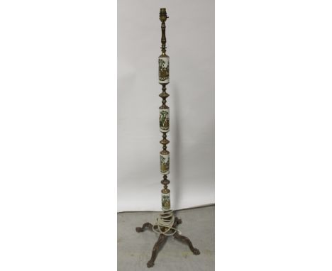 An early/mid-20th century brass and ceramic standard lamp, brass column with circular ceramic inserts painted with 18th centu