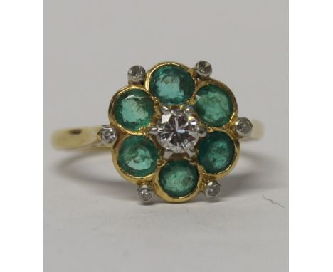 An 18ct gold and platinum floral cluster ring, one central diamond and six tourmaline surround, size N, approx 3.7g.