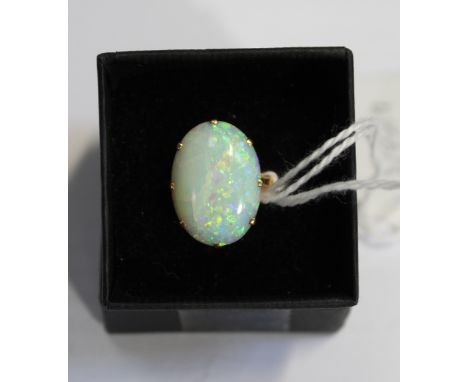 An 18ct yellow gold ladies' dress ring set with a large oval cabochon-cut opal, size L, approx 5.6g.